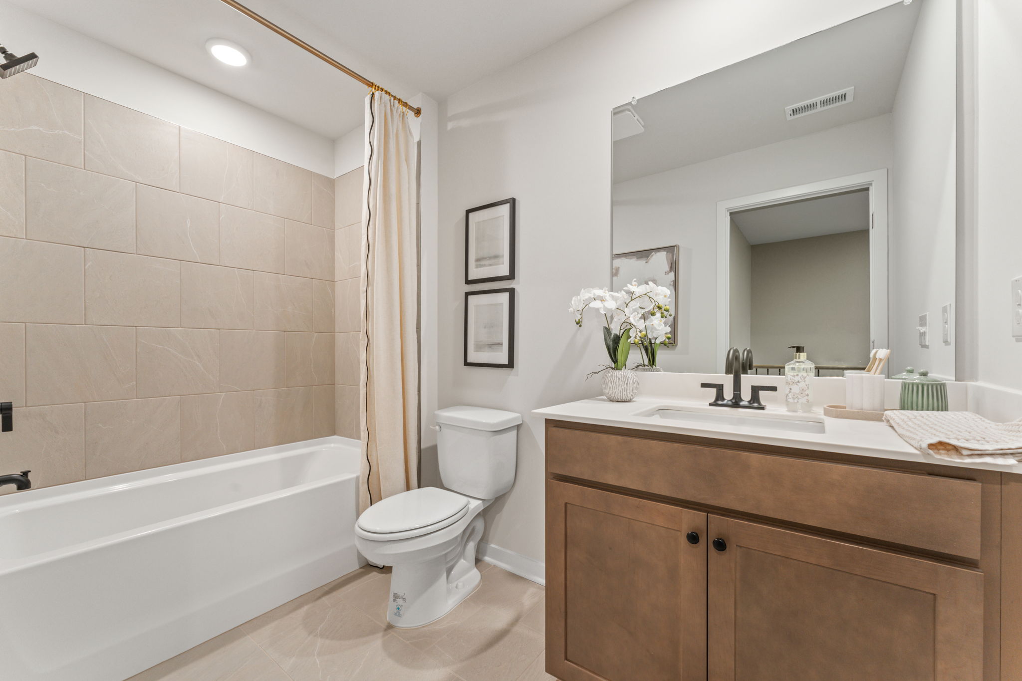 A bathroom with a tub toilet and sink.