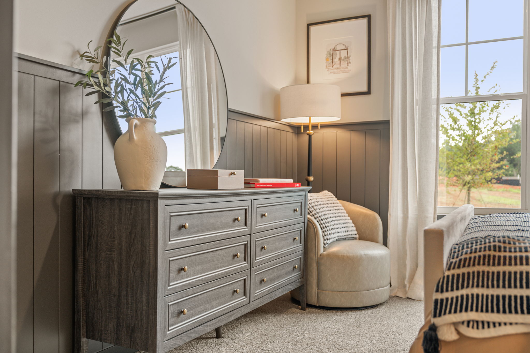 A room with a dresser and a chair.