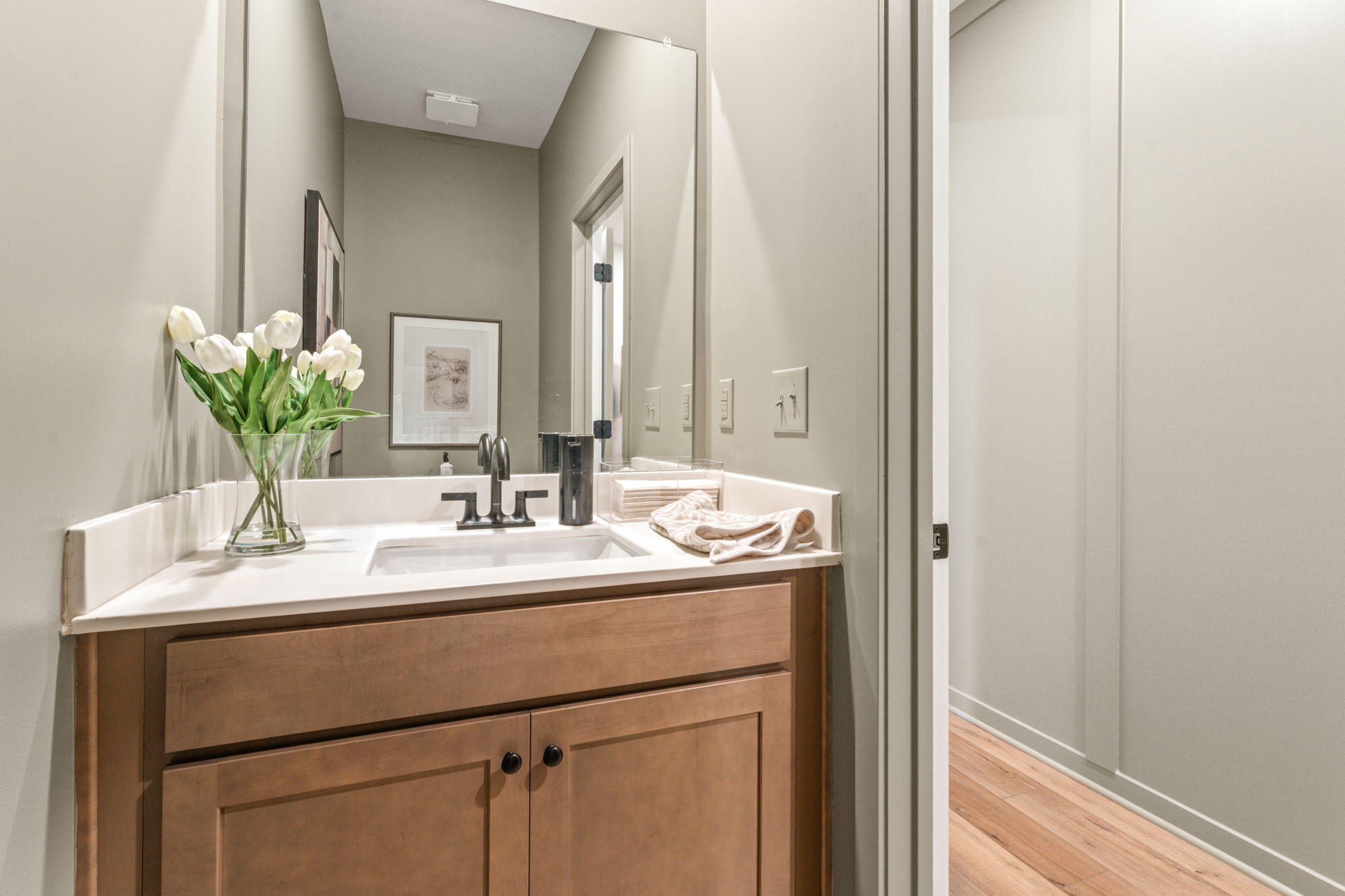 A bathroom with a sink and a mirror.