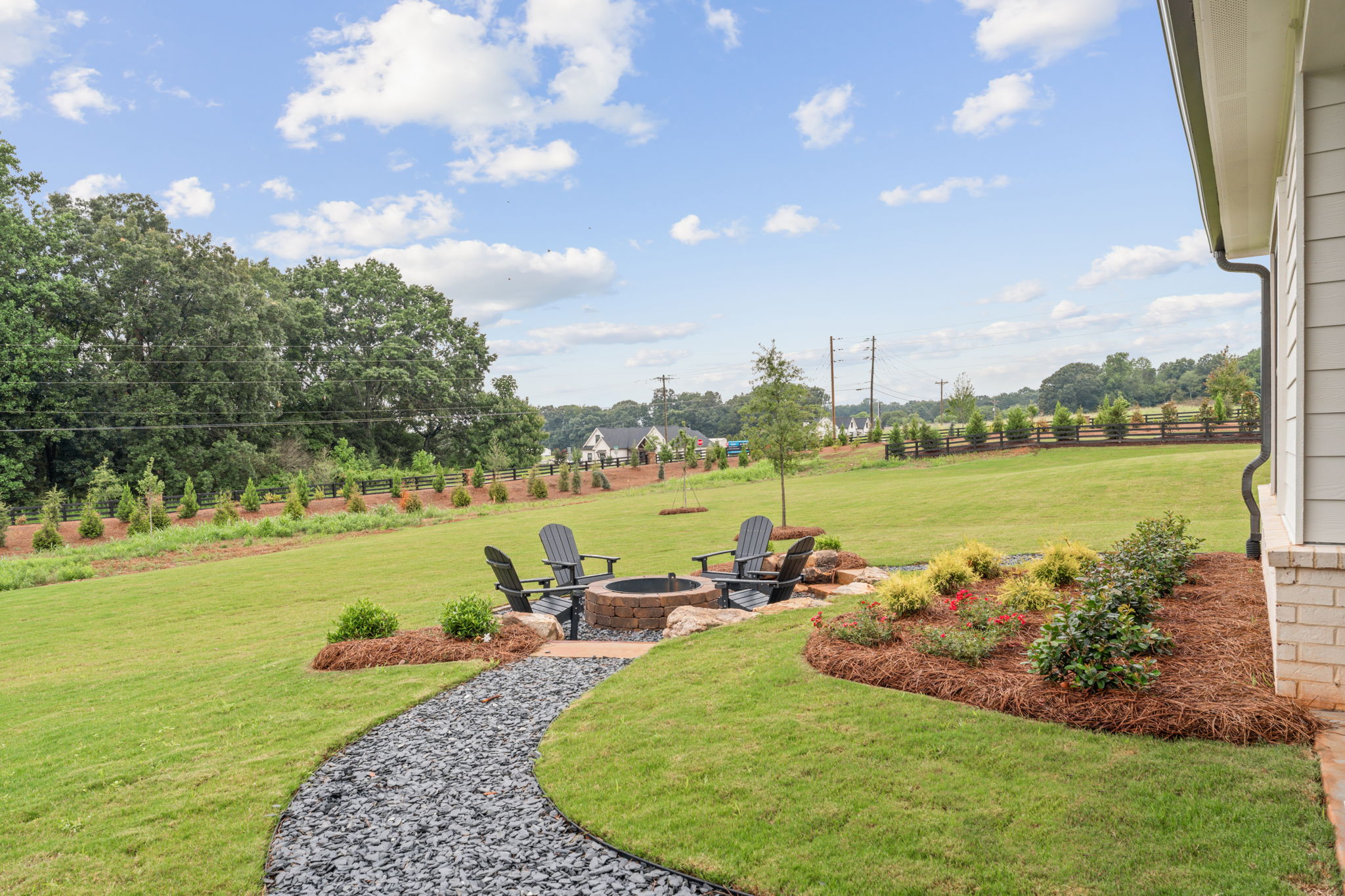 A backyard with a patio and chairs.