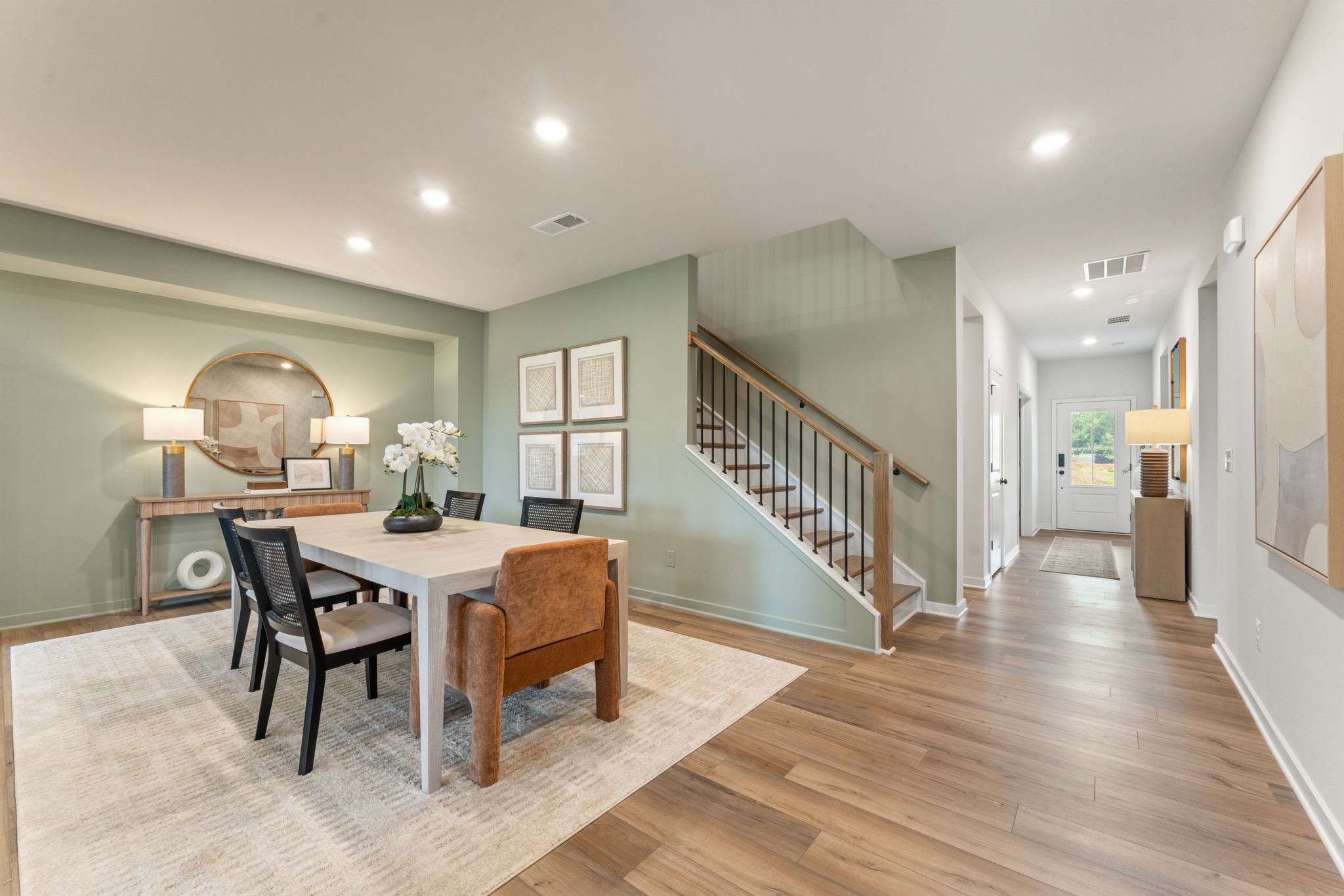 A dining room with a wood floor.