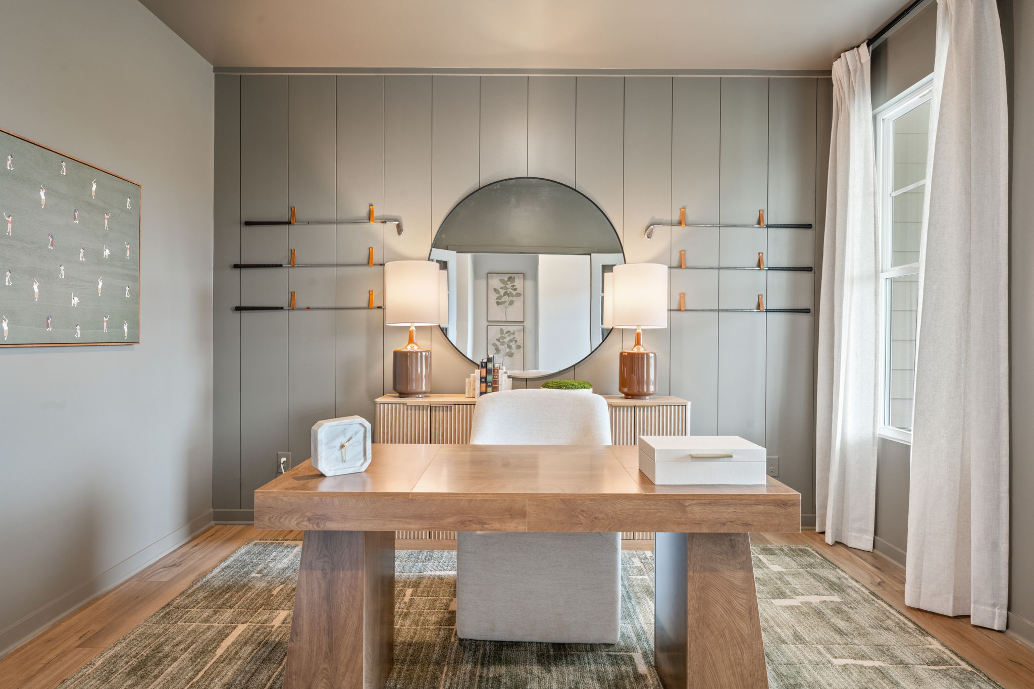 A room with a table and a mirror.