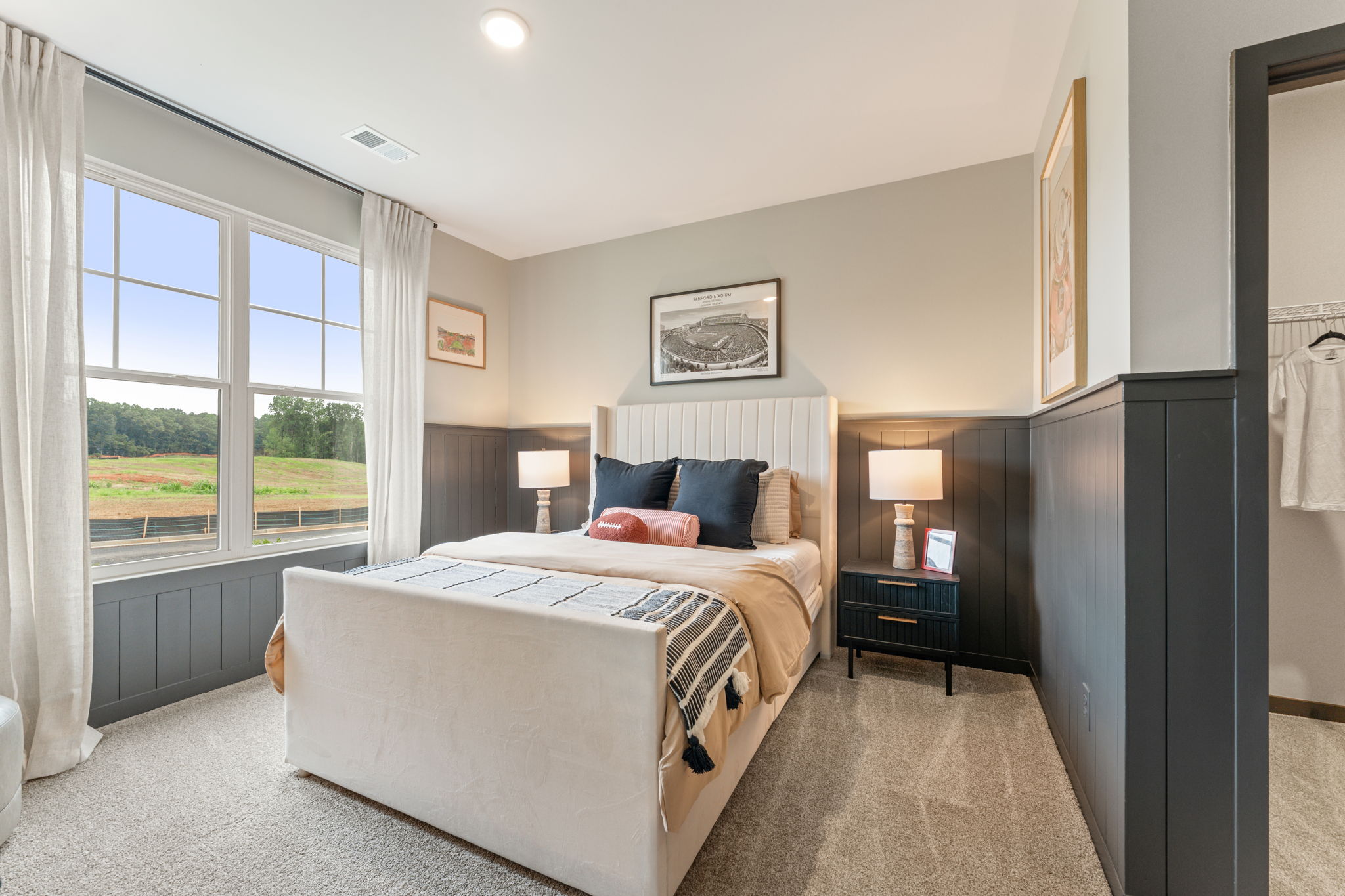 A bedroom with a large window.