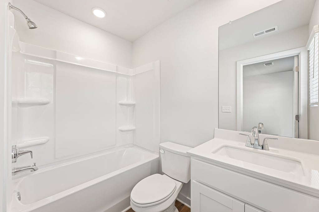 A bathroom with a tub toilet and sink.