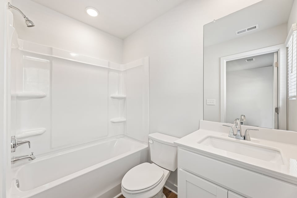 A bathroom with a tub toilet and sink.
