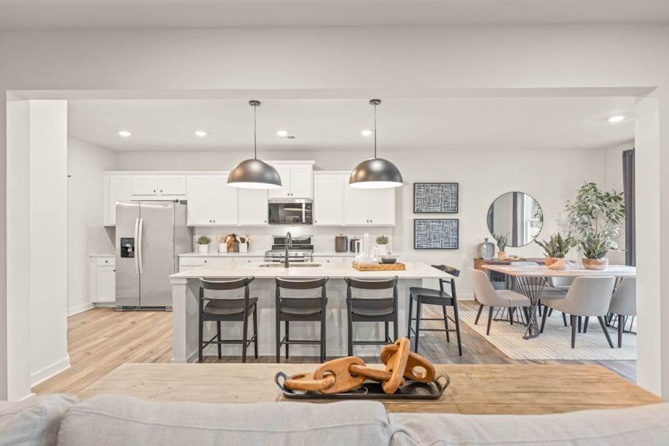 A kitchen with a table and chairs.