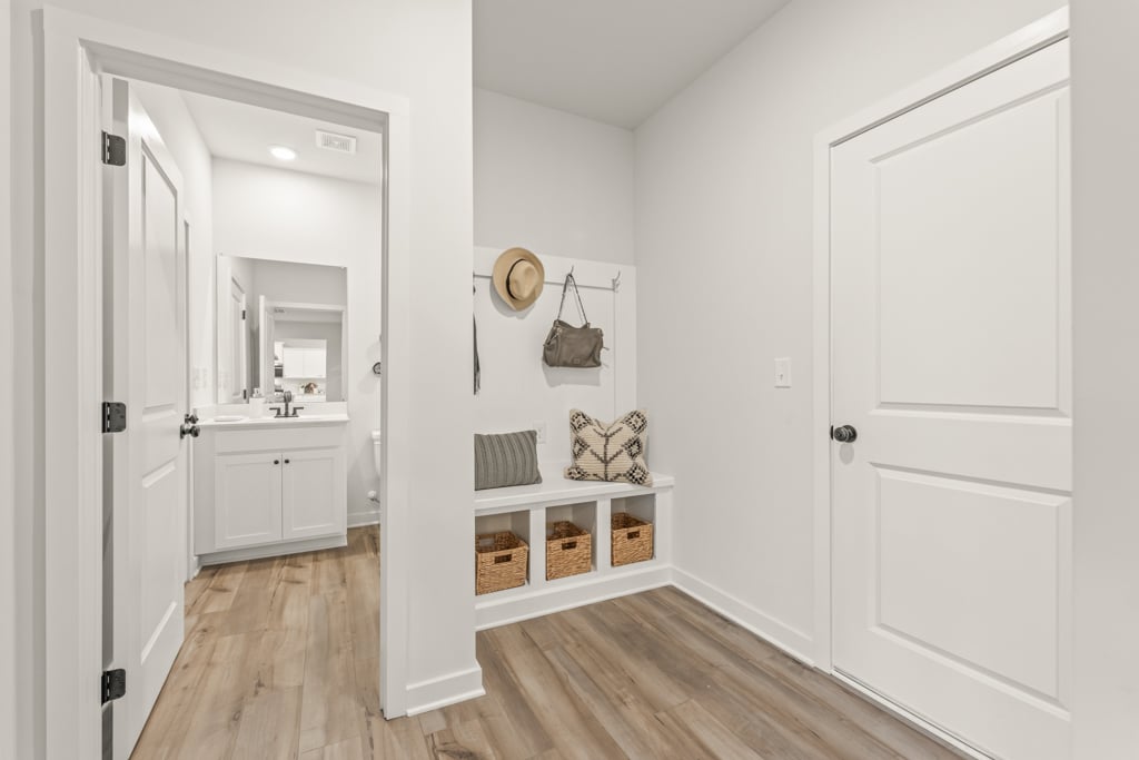 A white room with a wood floor.