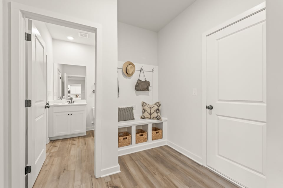 A white room with a wood floor.