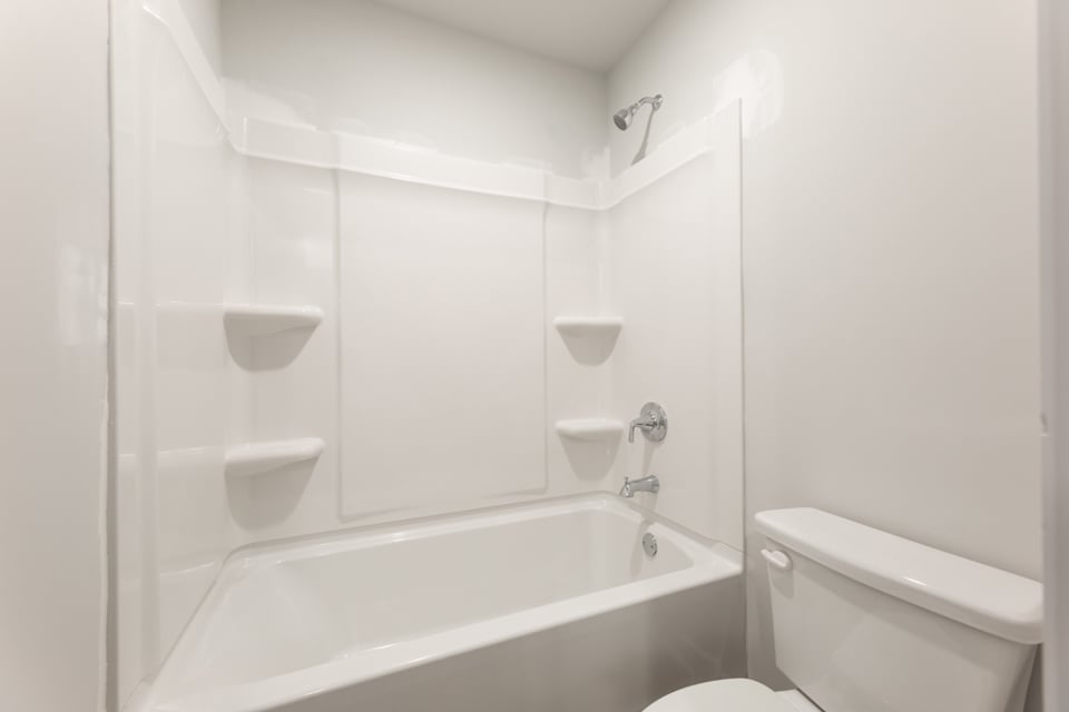 A bathroom with a bathtub toilet and sink.