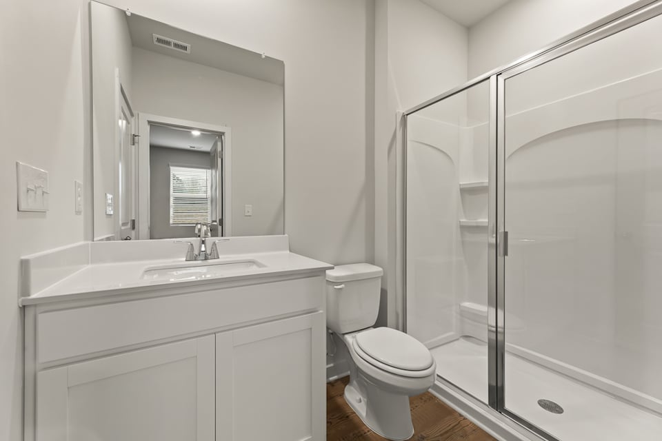 A bathroom with a glass shower.