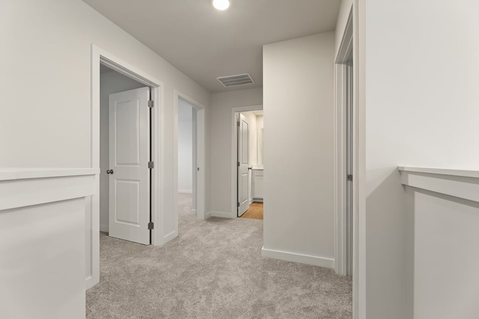 A hallway with white walls.