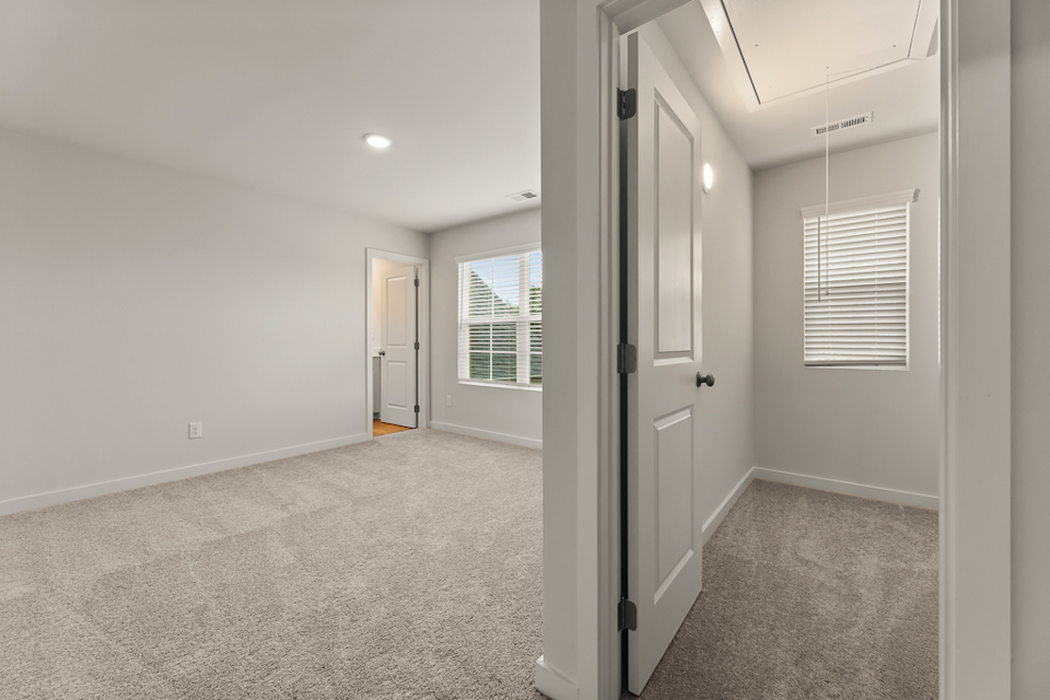 A hallway with white doors.