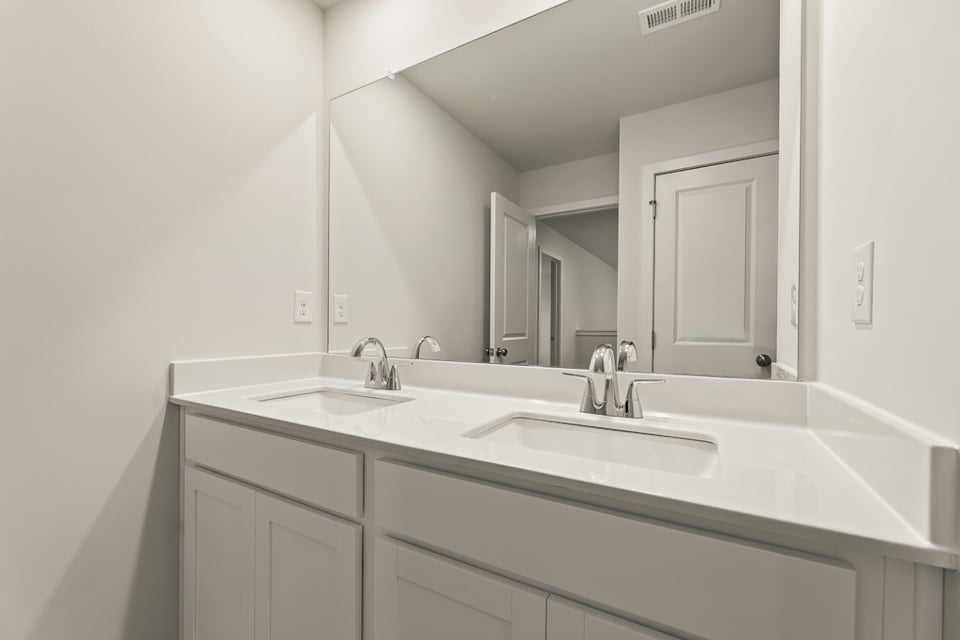 A bathroom with a large mirror.
