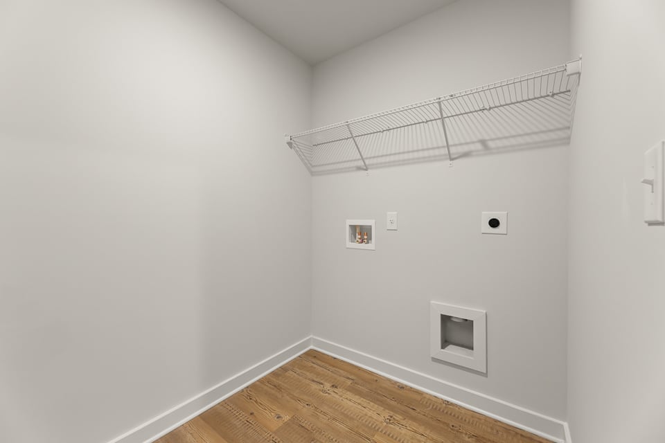 A white room with a wood floor.