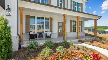 A house with a patio and a flower bed.