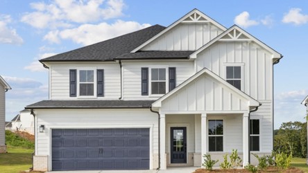 A white house with a garage.