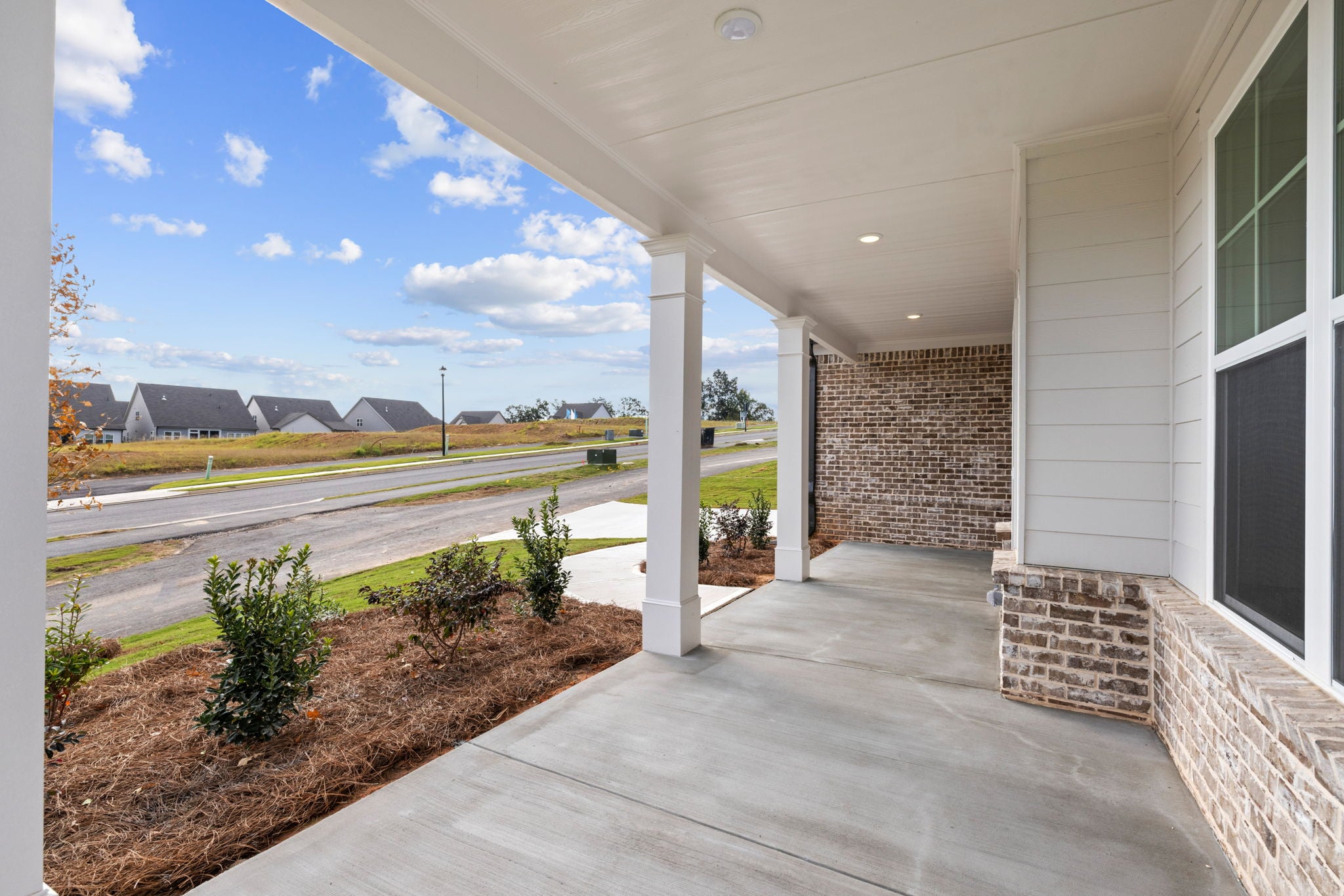 A building with a walkway and grass.