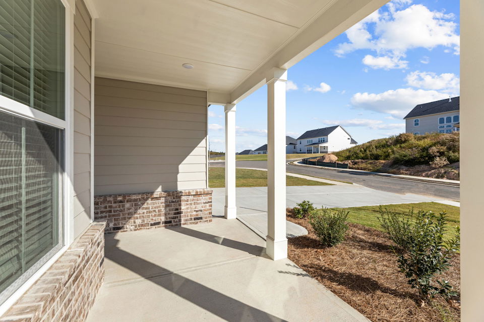 A house with a walkway and a road.
