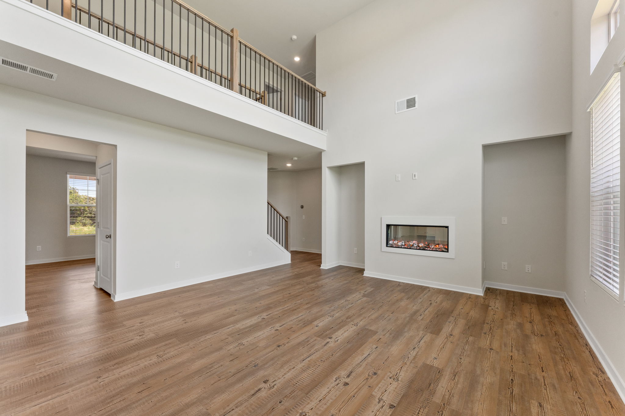 A room with white walls and wood floors.