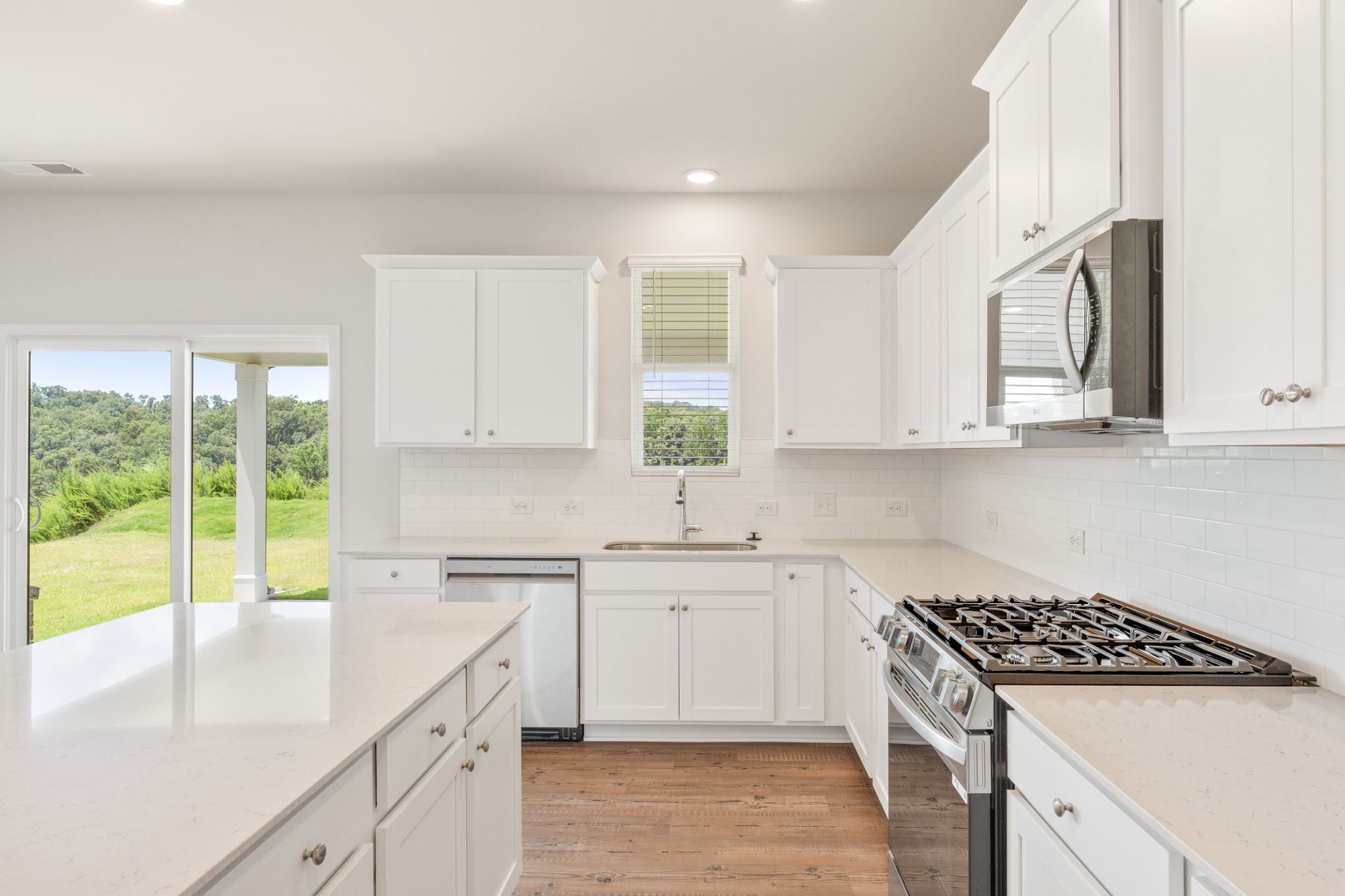 A kitchen with white cabinets.