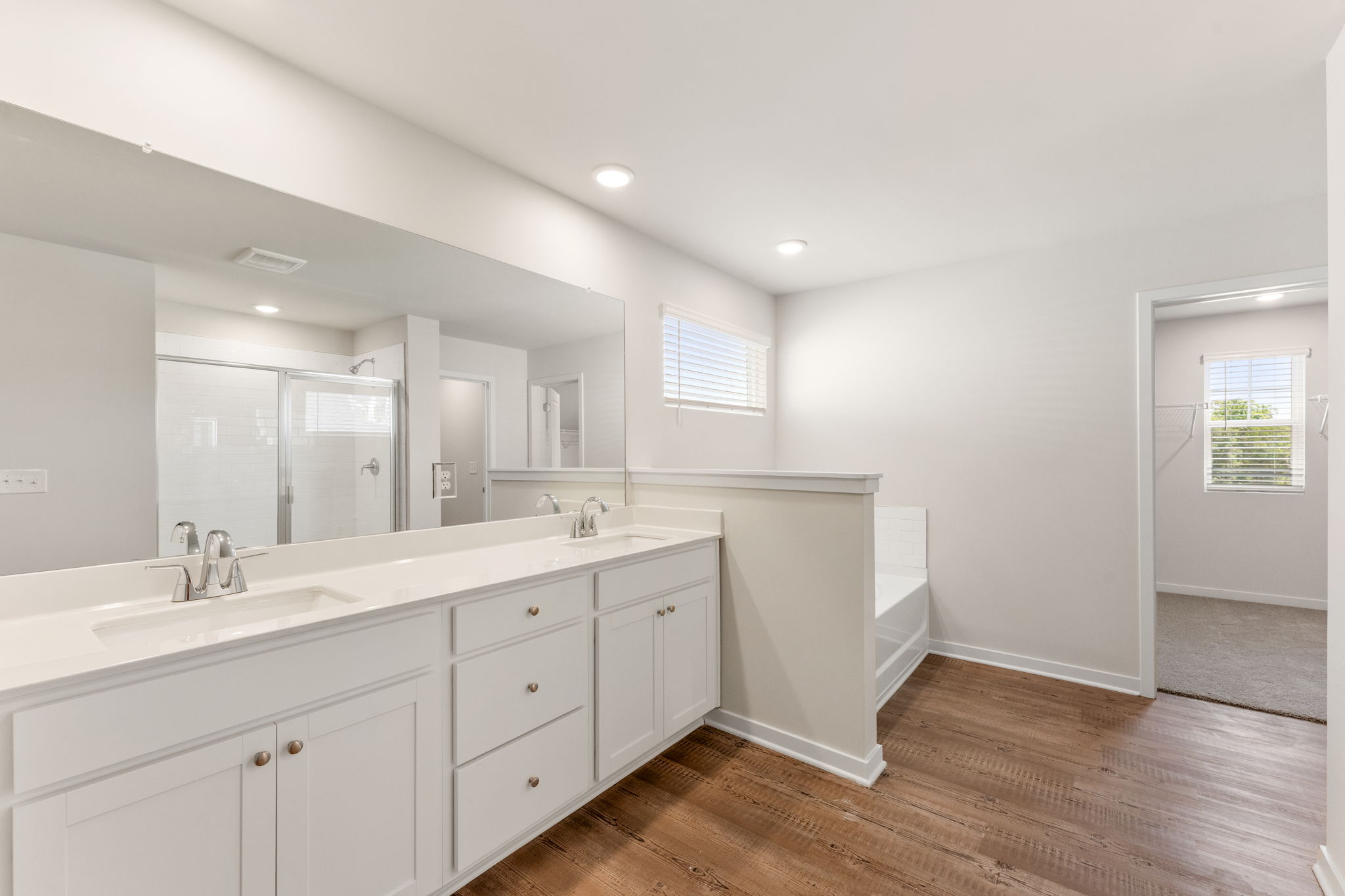 A bathroom with white cabinets.
