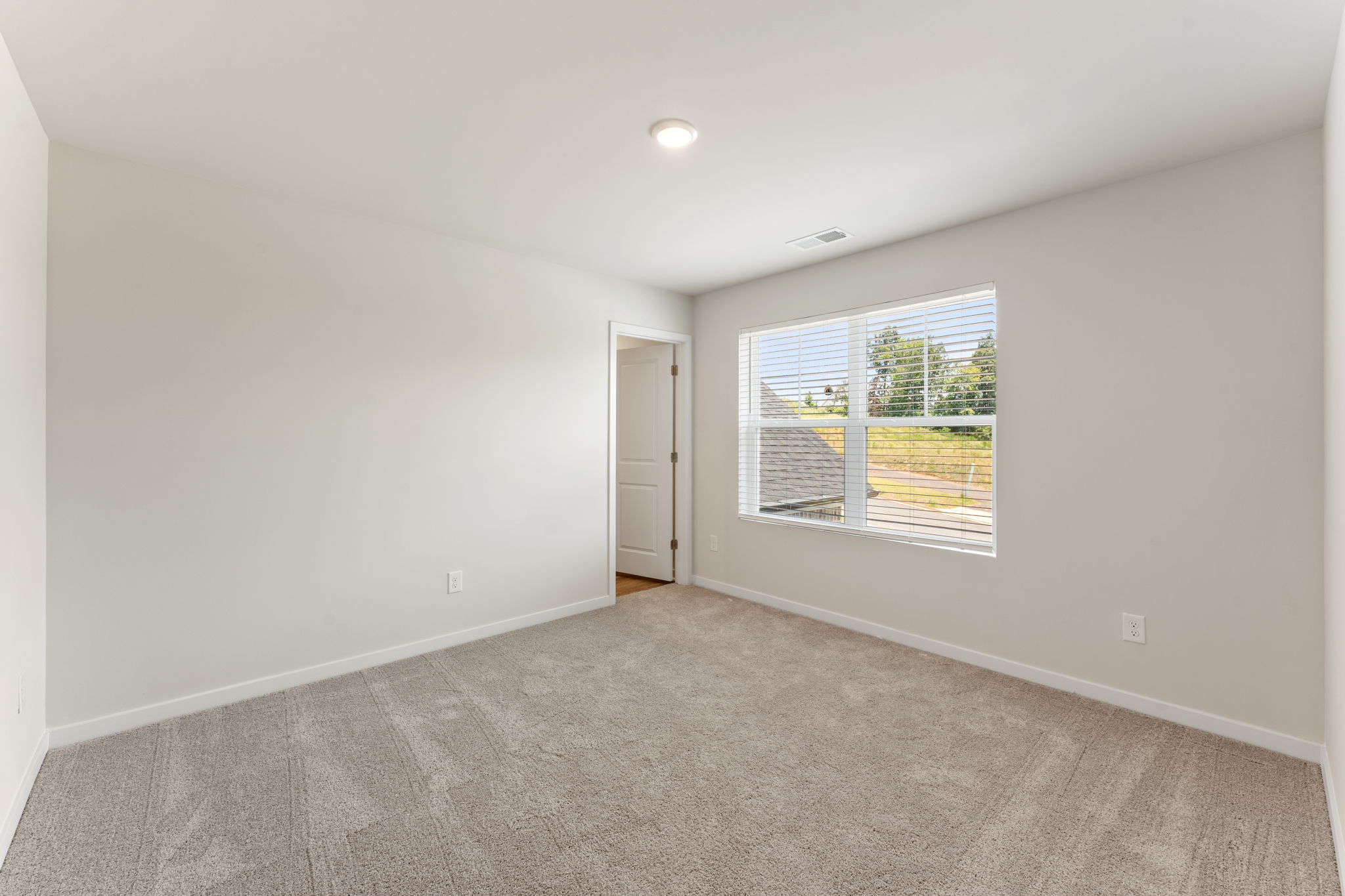 A room with a window and a door.