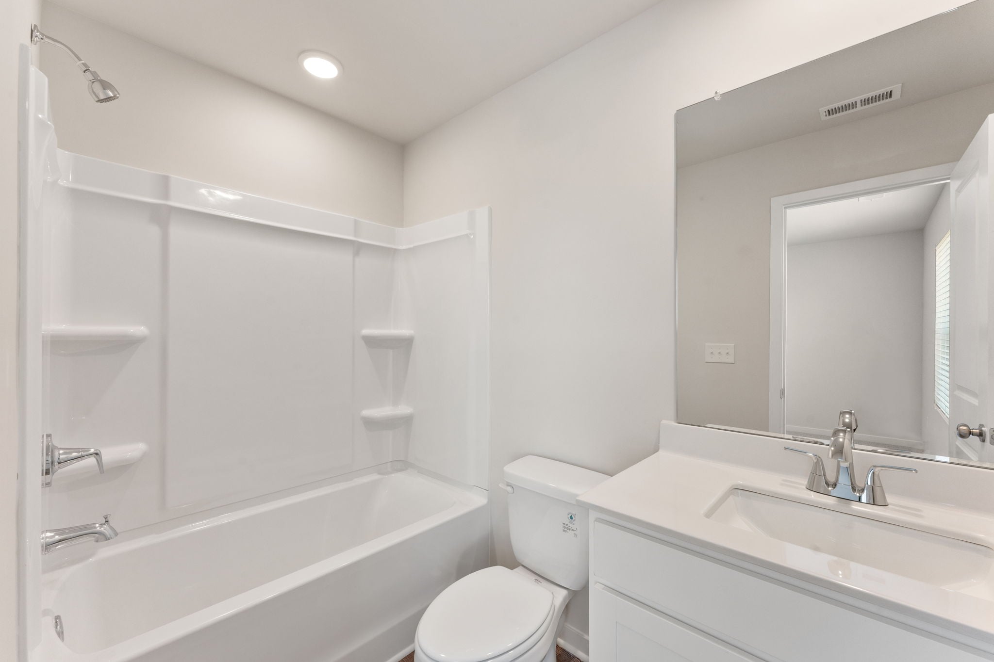 A bathroom with a tub toilet and sink.