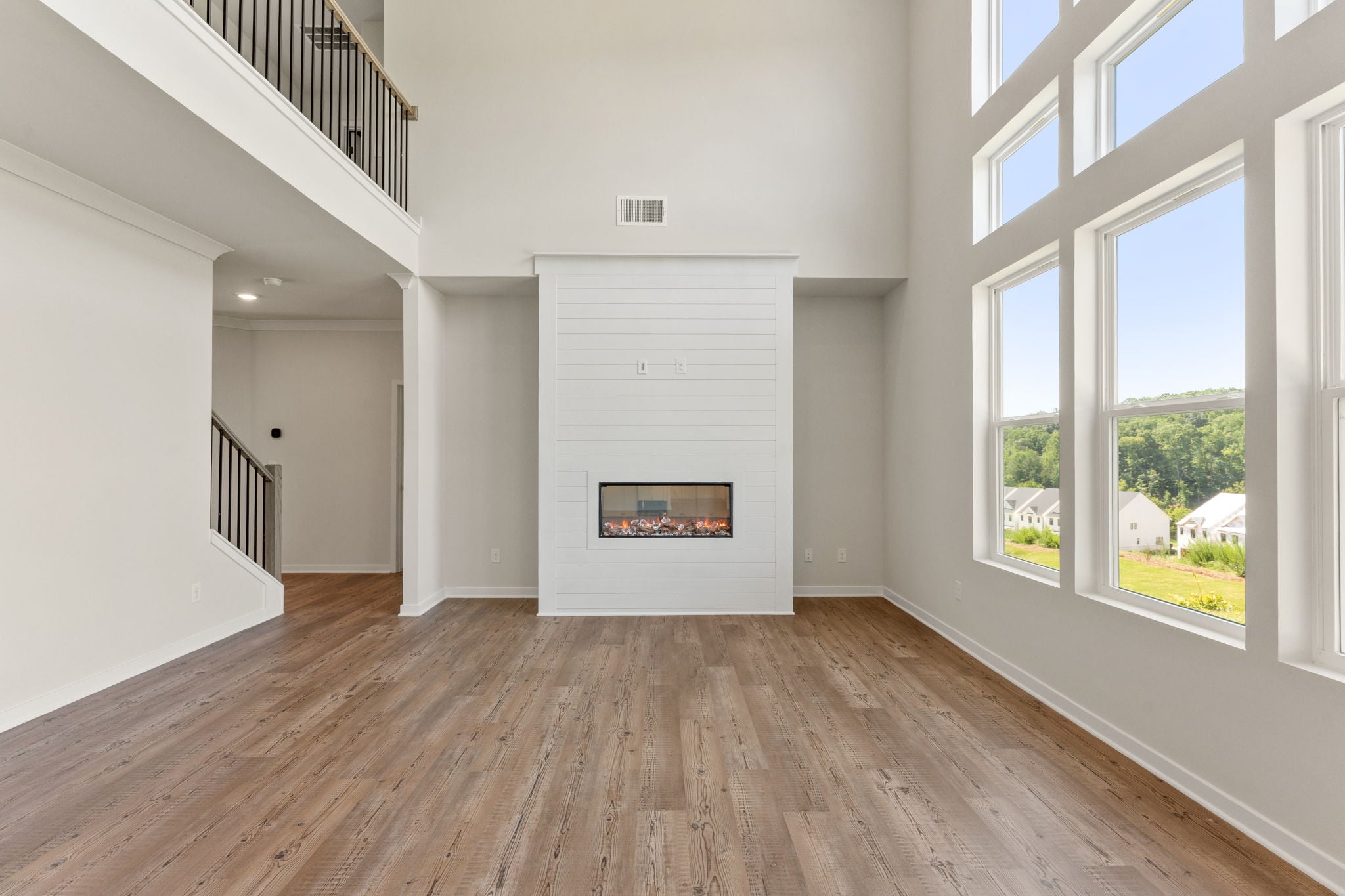 A room with a fireplace and a wood floor.