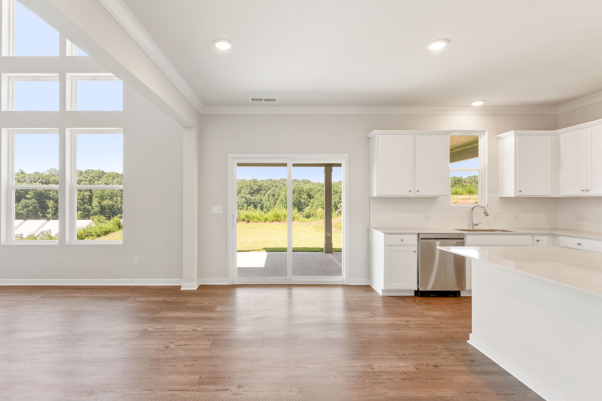 A kitchen with white cabinets.