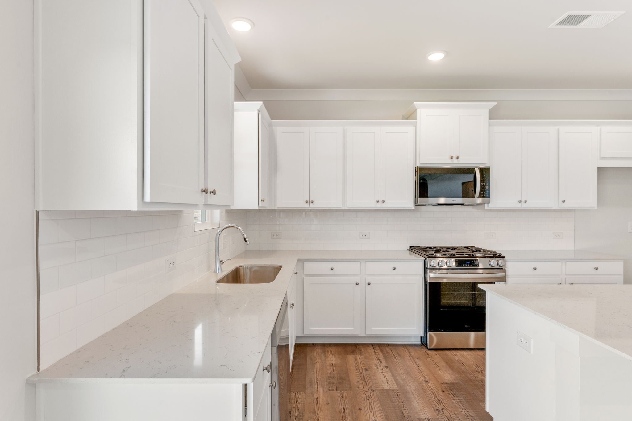 A kitchen with white cabinets.
