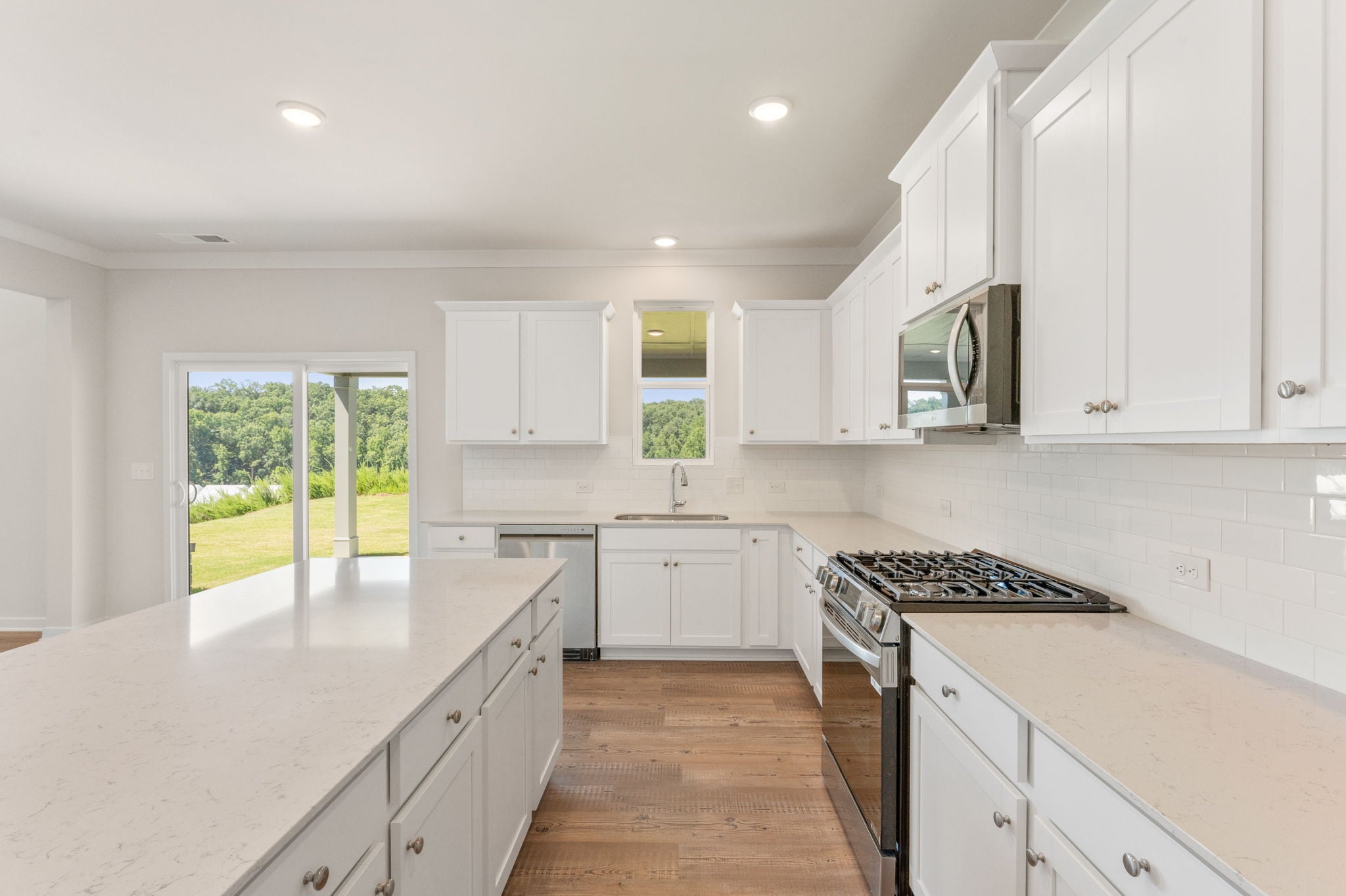 A kitchen with white cabinets.