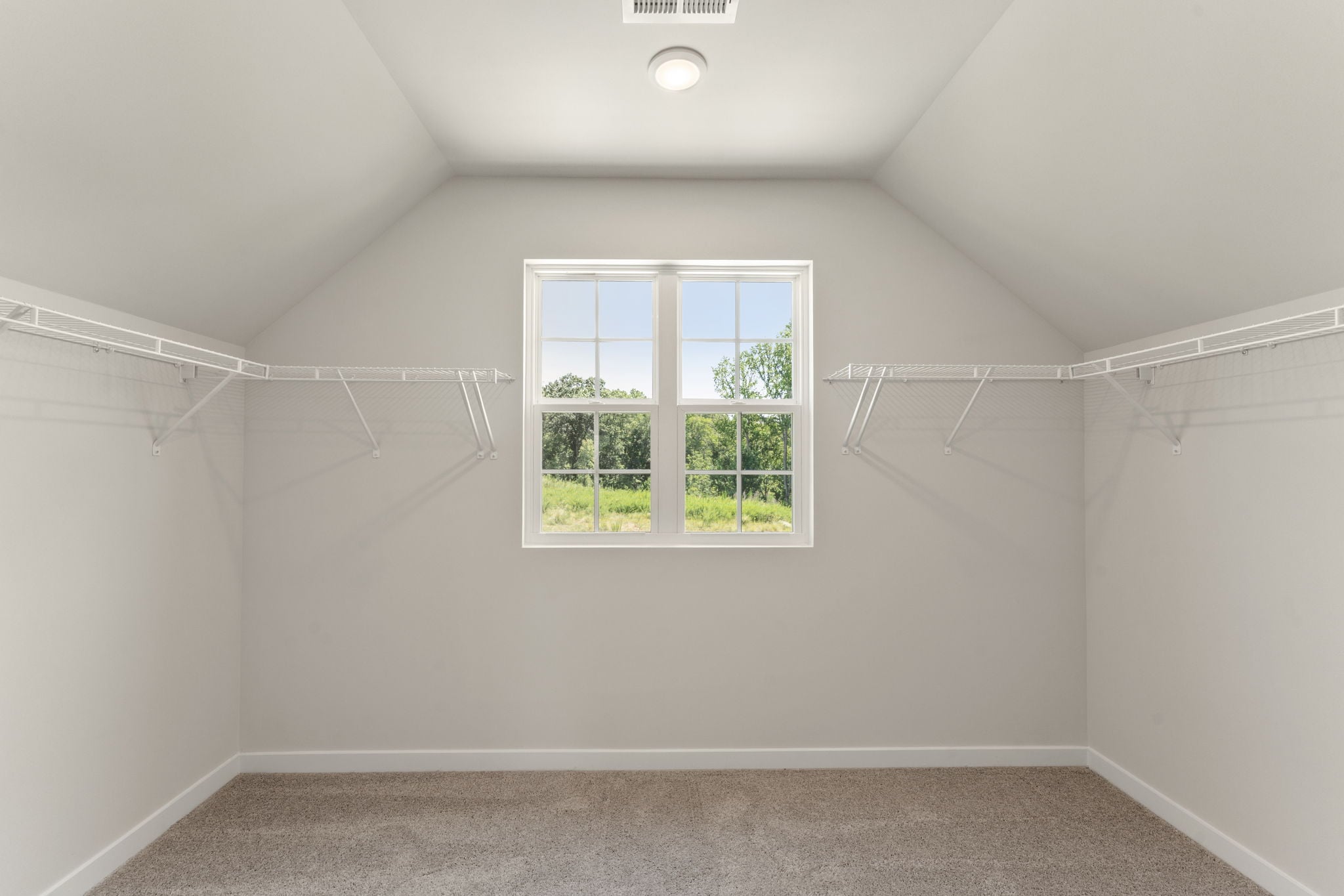 A room with a window and a carpet.