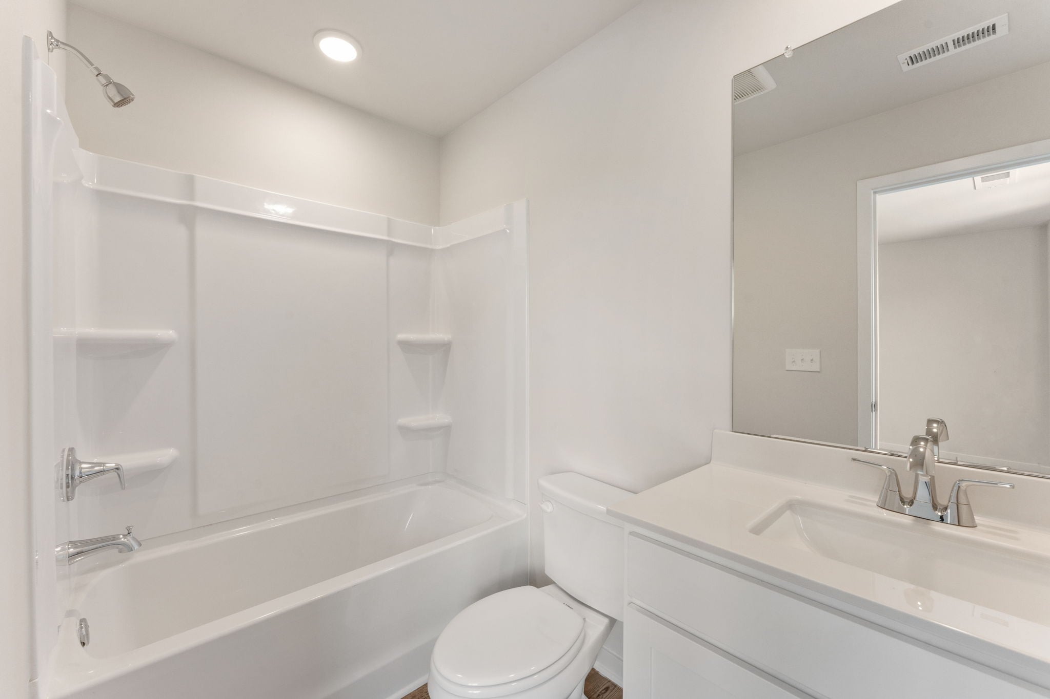 A bathroom with a tub toilet and sink.