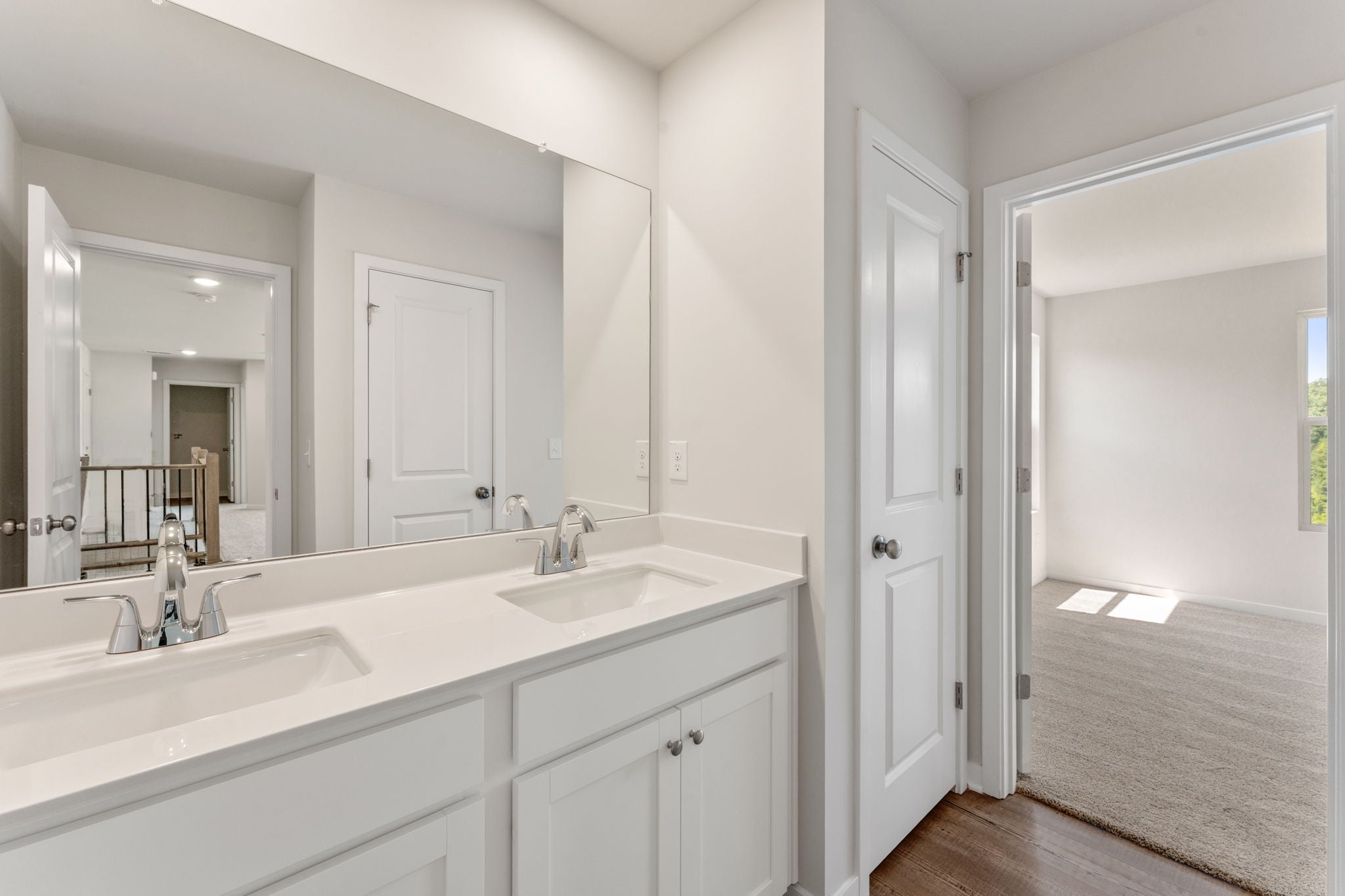 A bathroom with a large mirror.