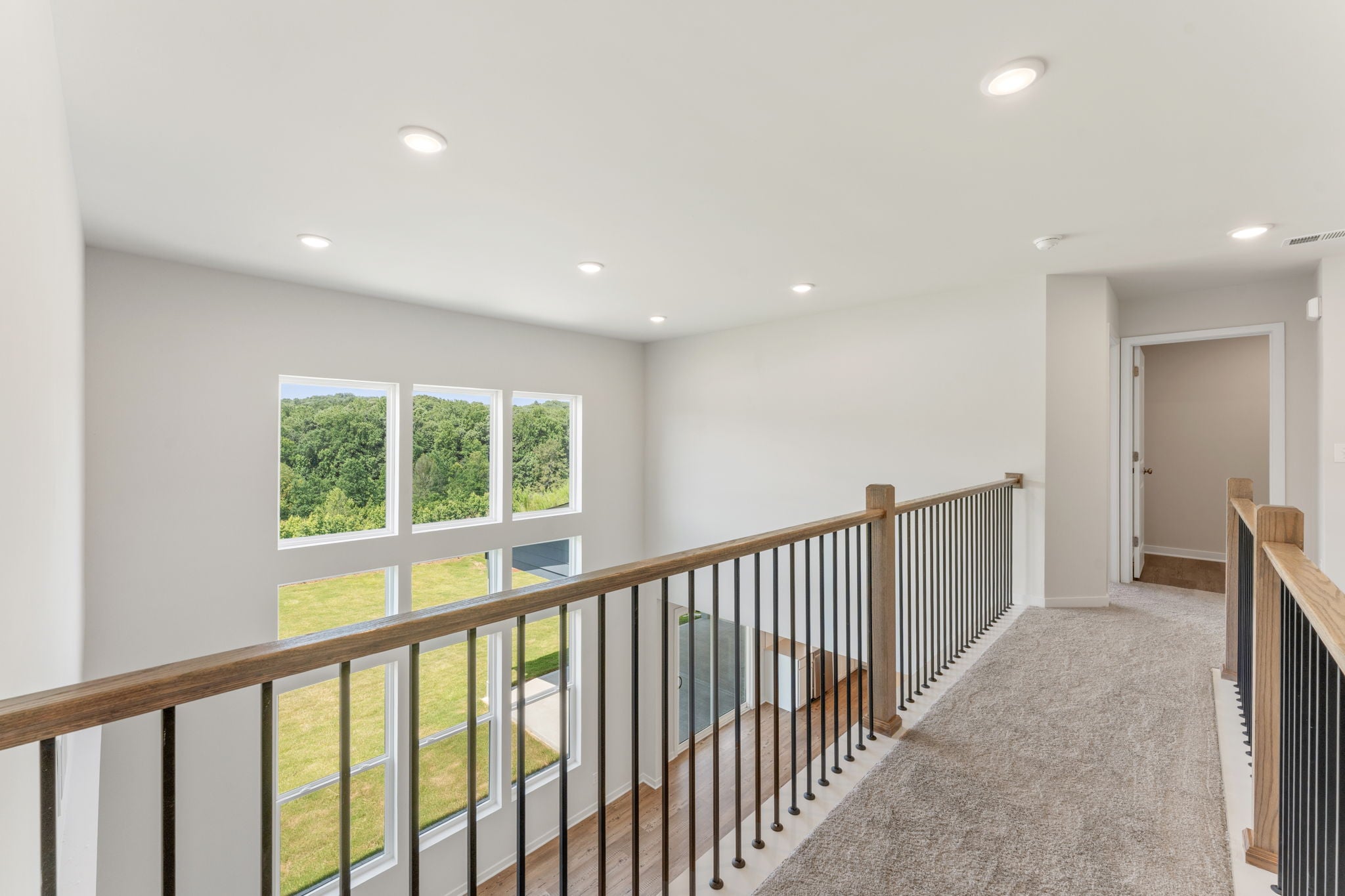 A room with a railing and windows.