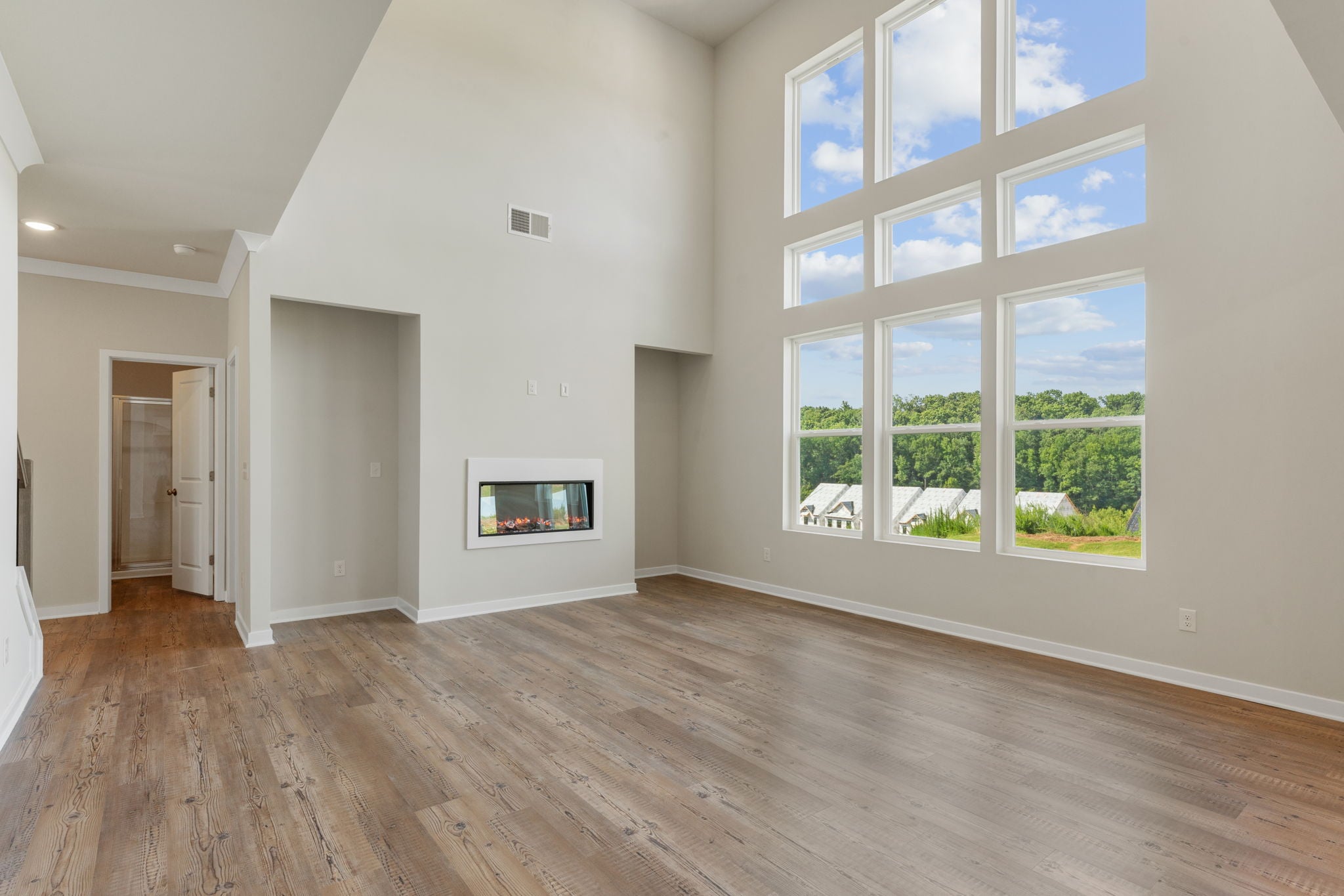 A room with a fireplace and a wood floor.