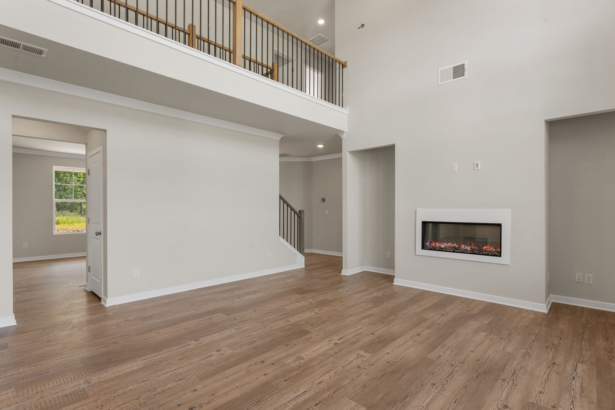 A room with a fireplace and wood floors.