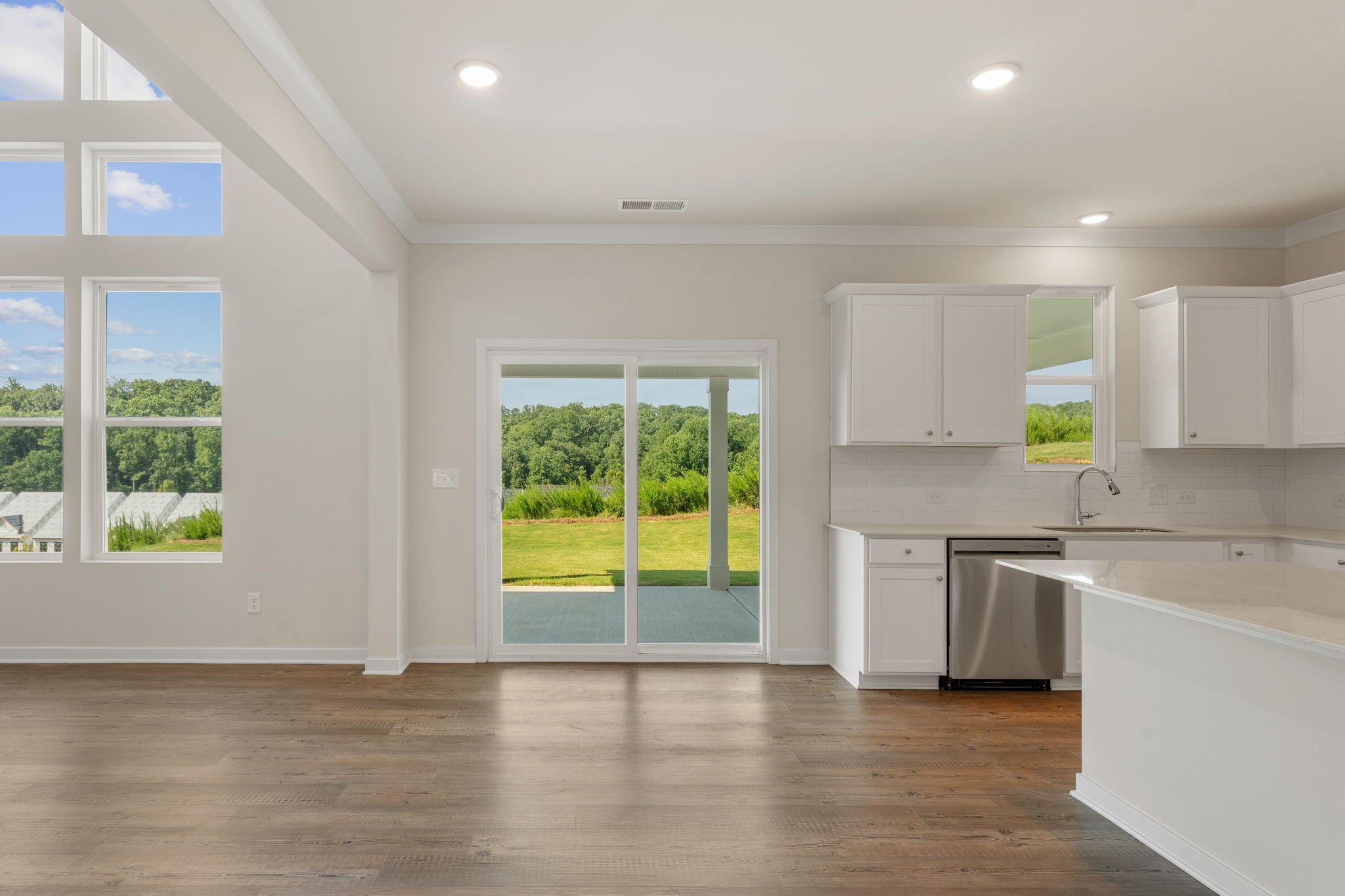 A kitchen with white cabinets.
