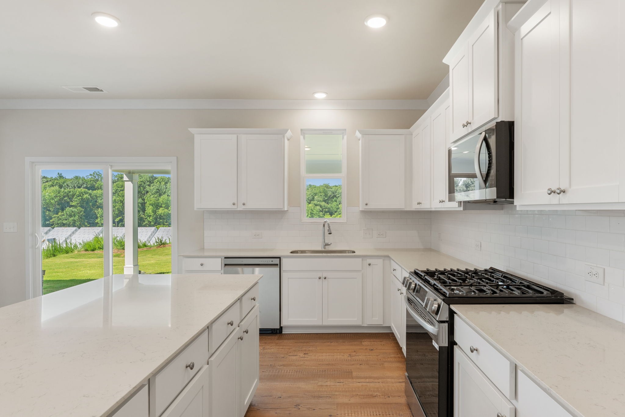 A kitchen with white cabinets.