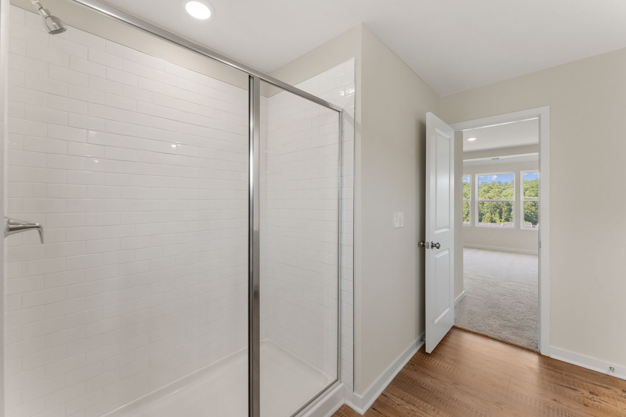 A room with a glass shower.