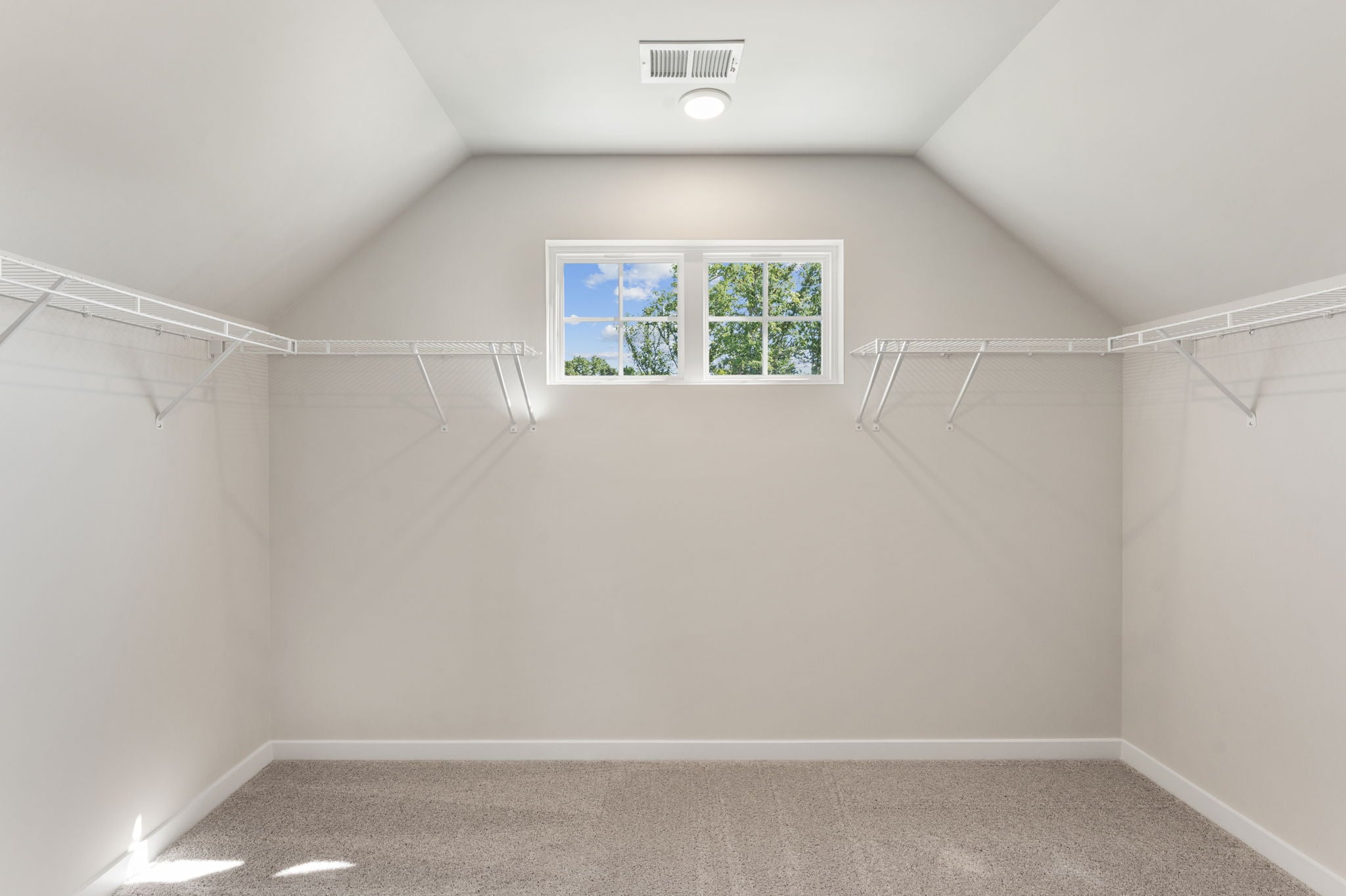 A white room with a window.