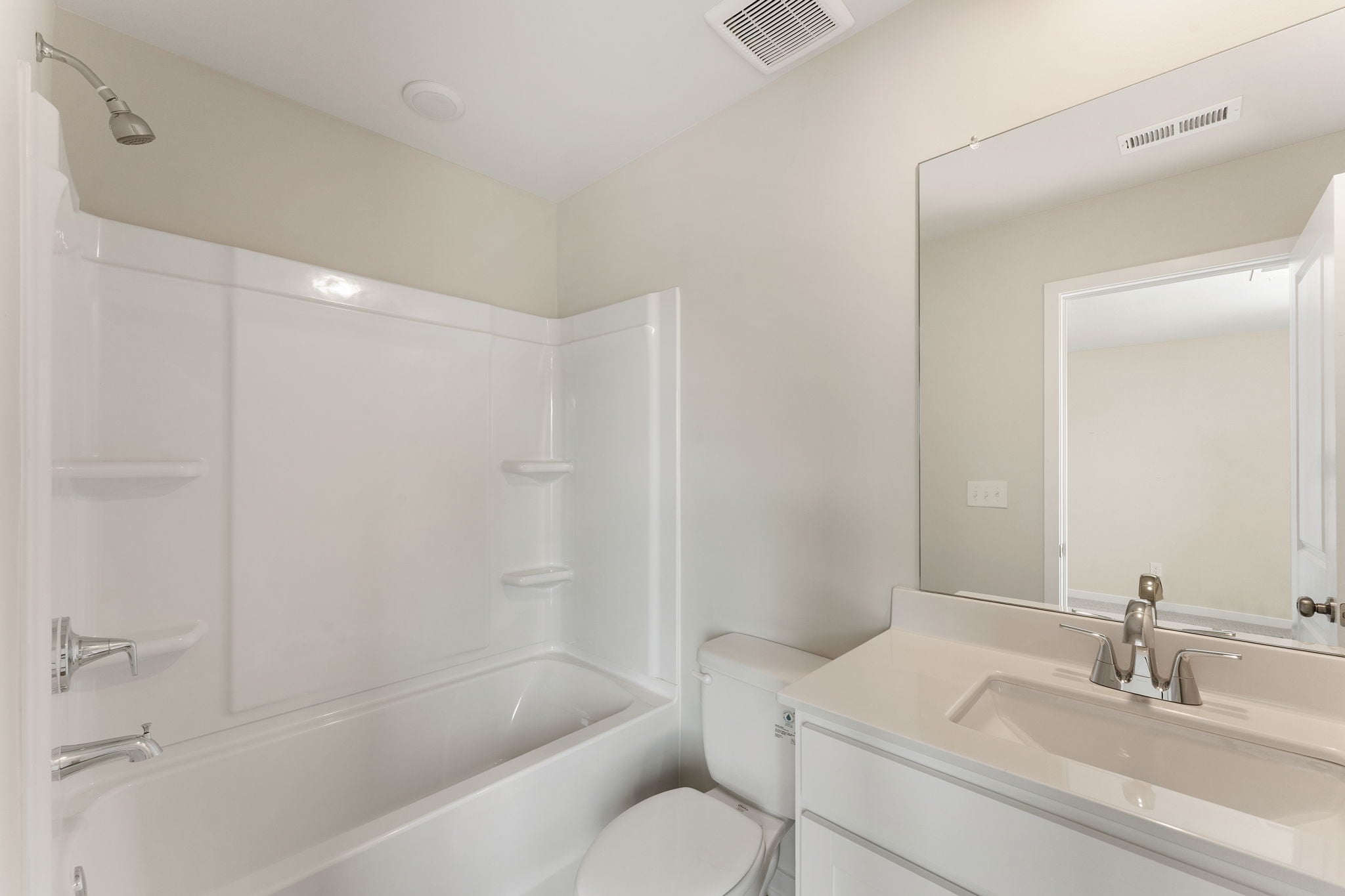 A bathroom with a tub toilet and sink.