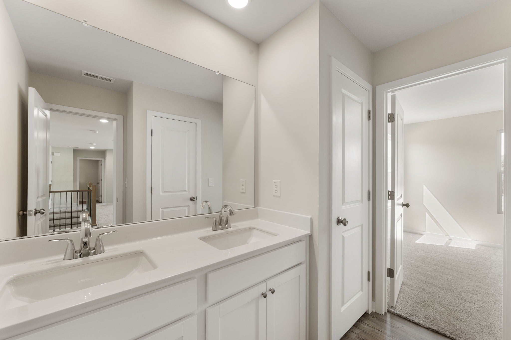 A bathroom with a large mirror.