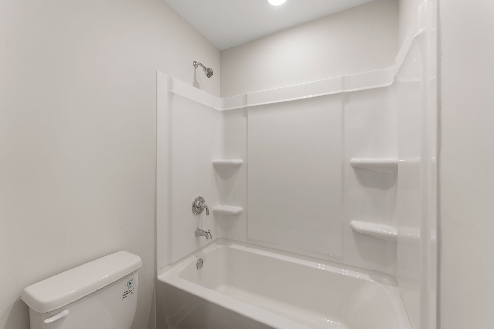 A bathroom with a tub toilet and sink.