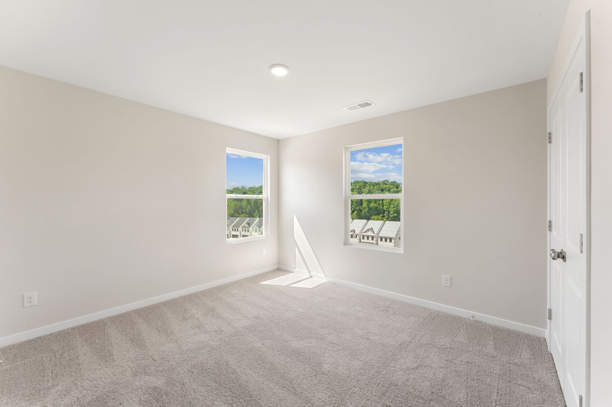 A room with a window and a carpet.