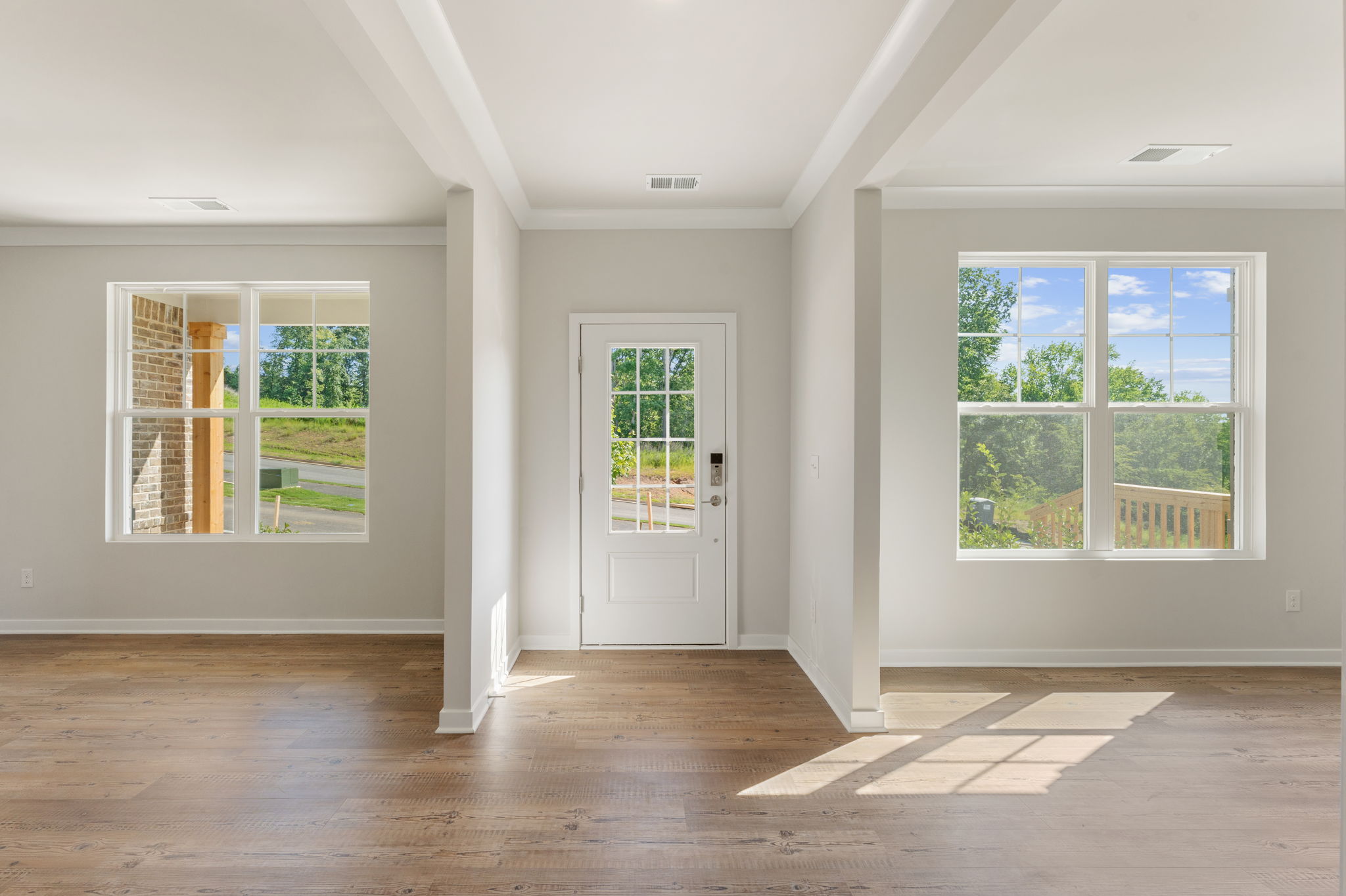 A room with windows and a wood floor.