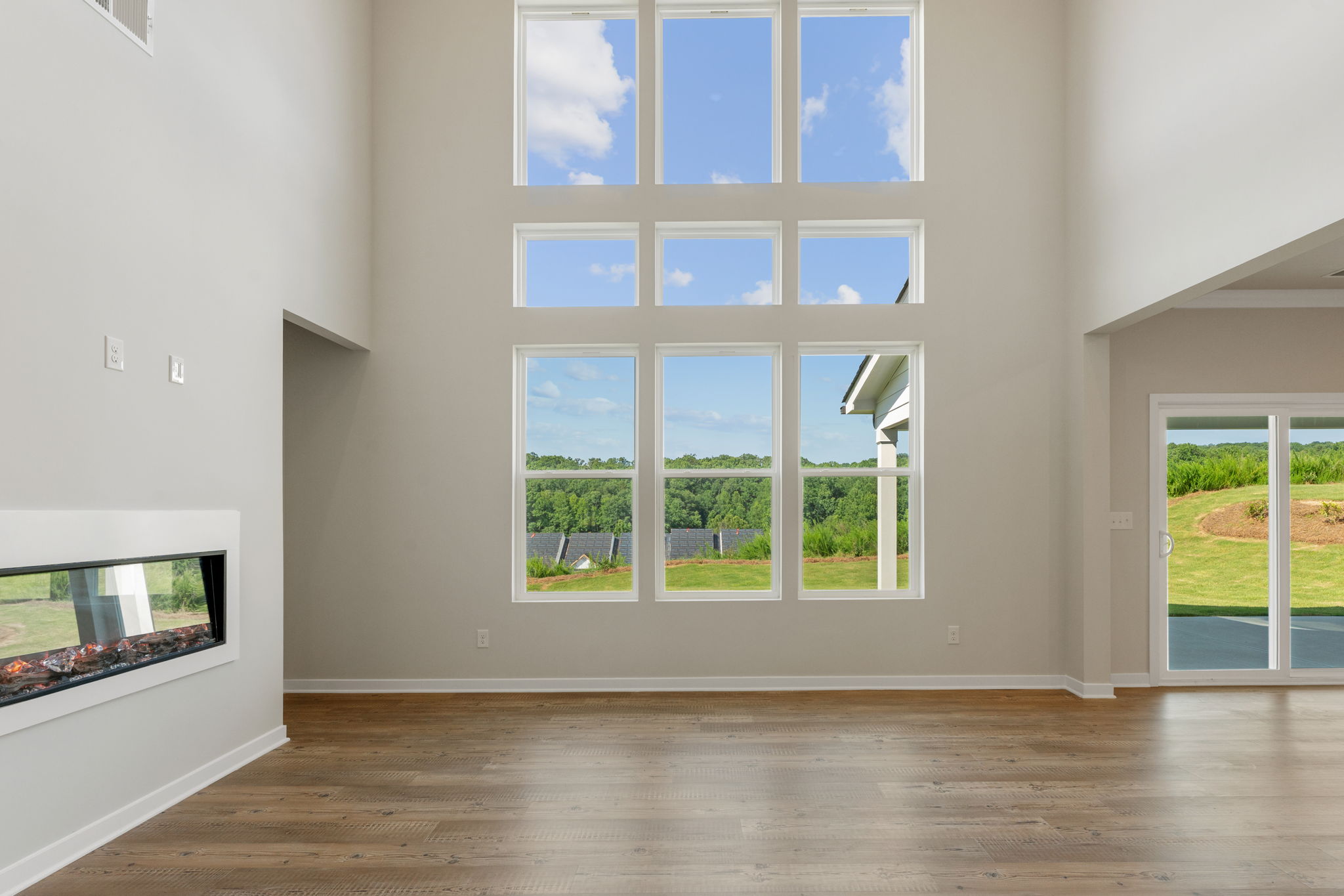 A room with windows and a wood floor.