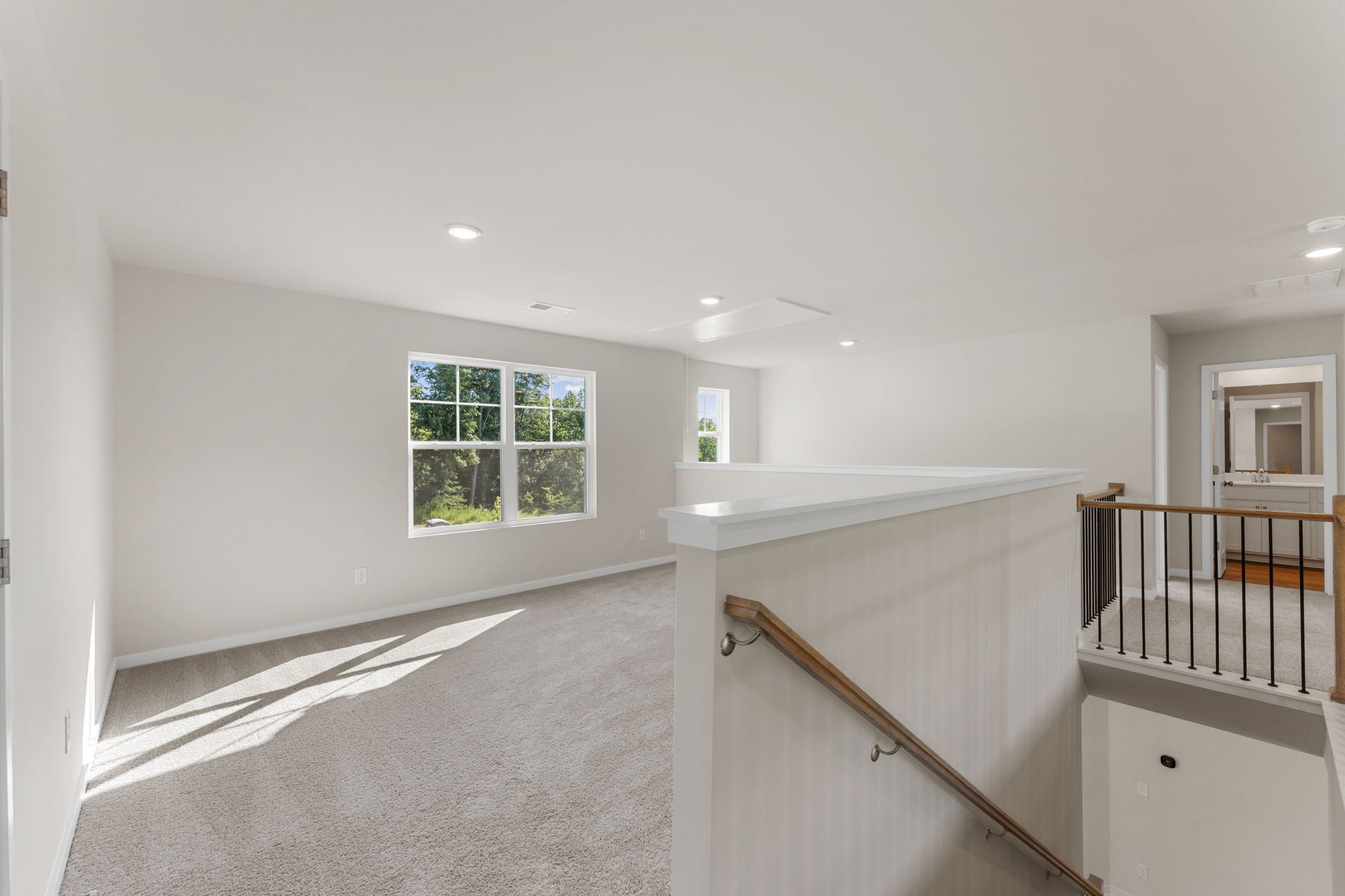 A room with a staircase and a window.