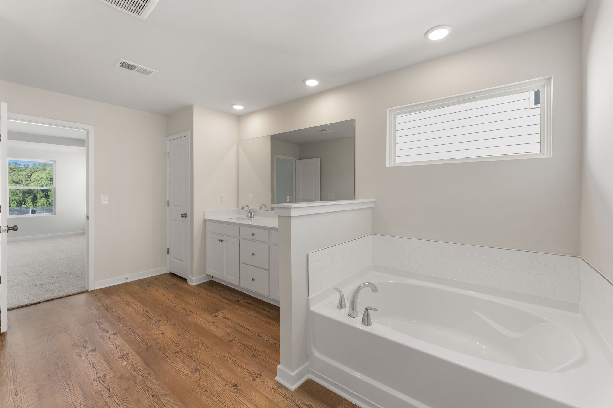 A bathroom with a tub and sink.
