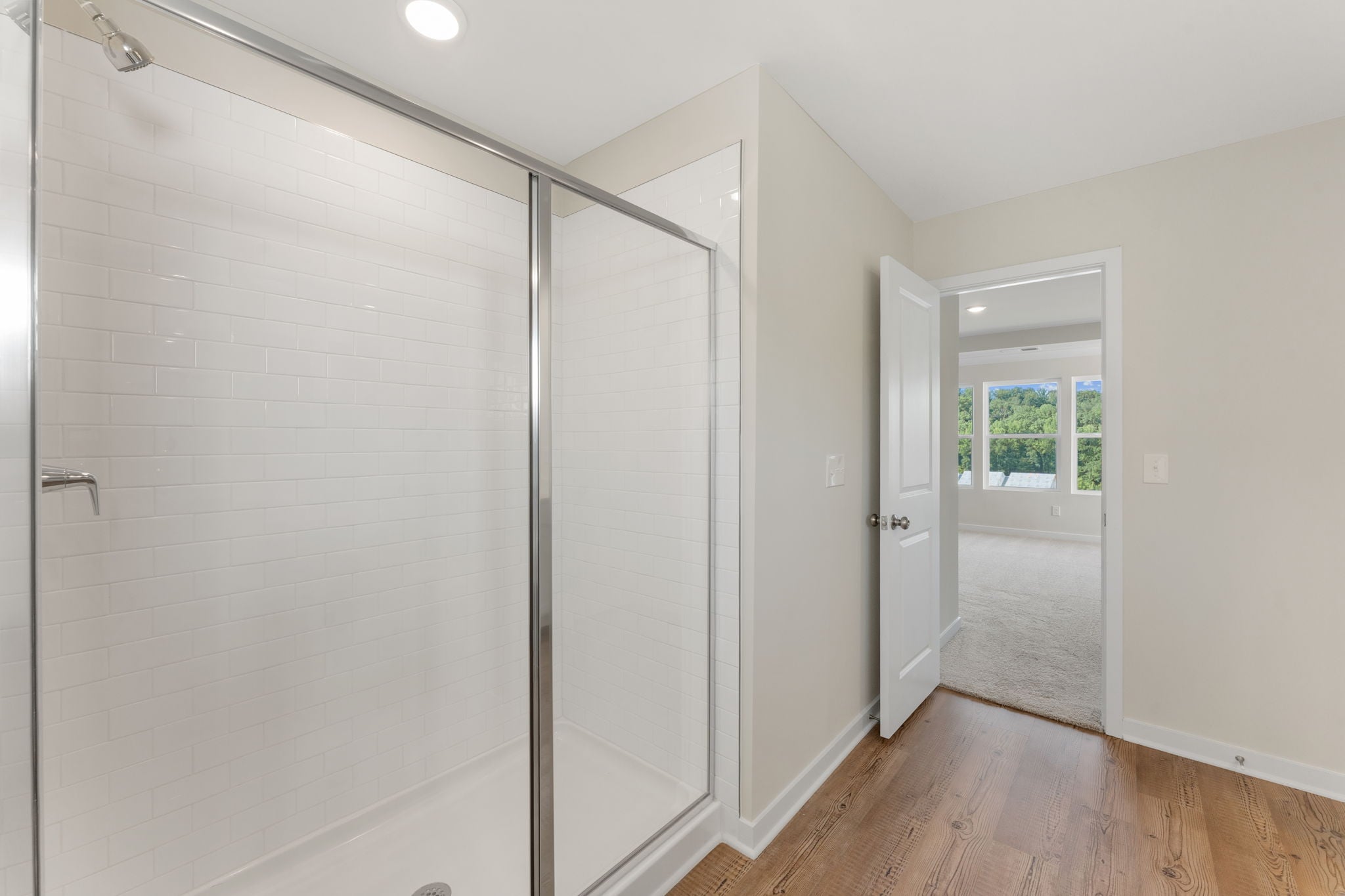 A room with a glass shower.